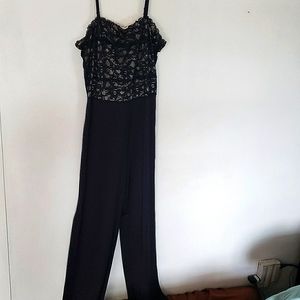 Black Jumpsuit lace top with side leg slits. elegant. Fashionable onTrend size